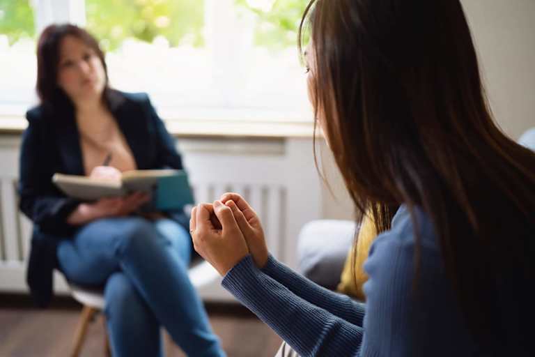 Addictions and recovery counselor speaking to client